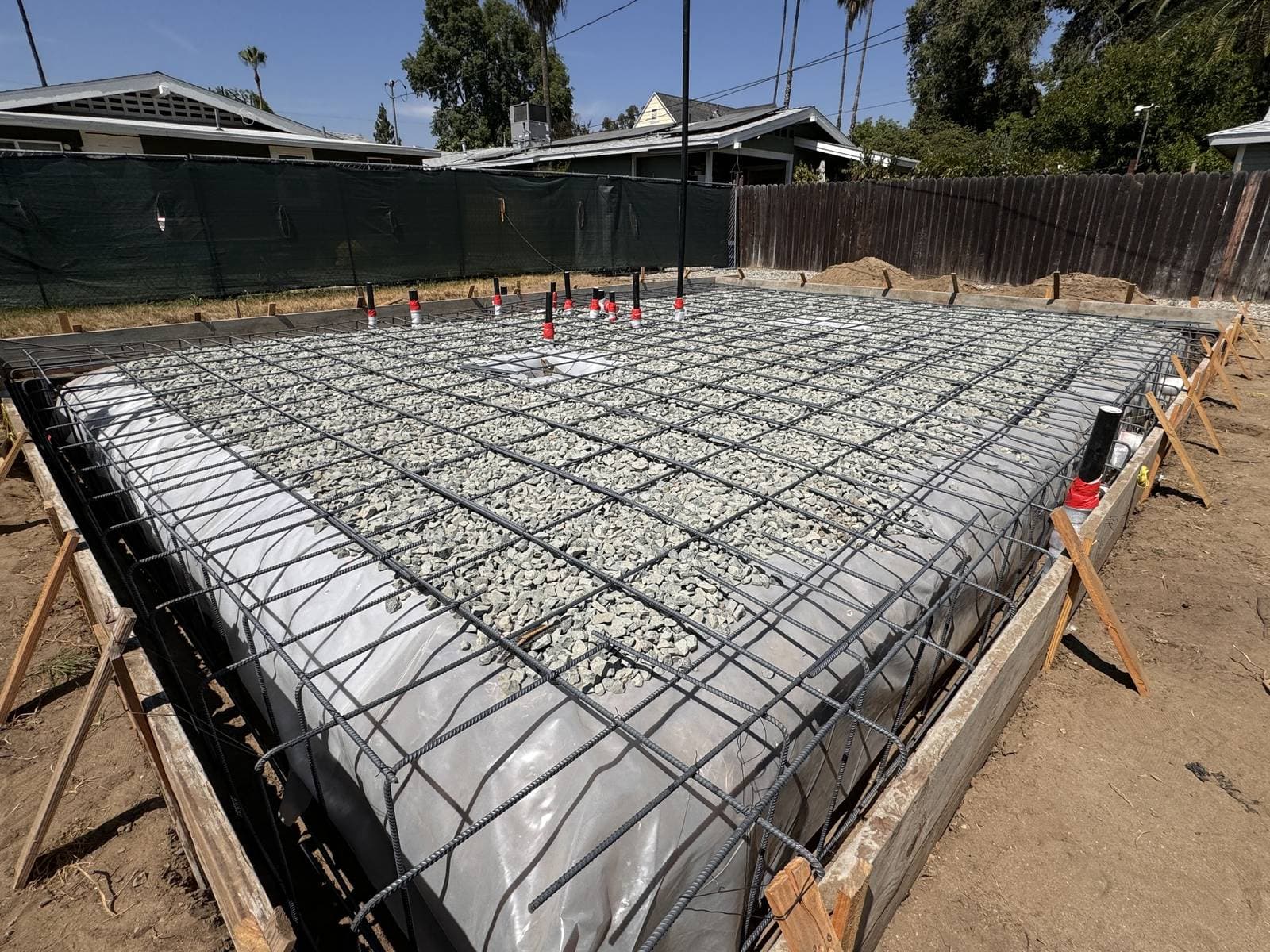MJ Remodel job photo from an ADU completed in Redlands, CA: steel rebar in the foundation forms, with plumbing rough-in
