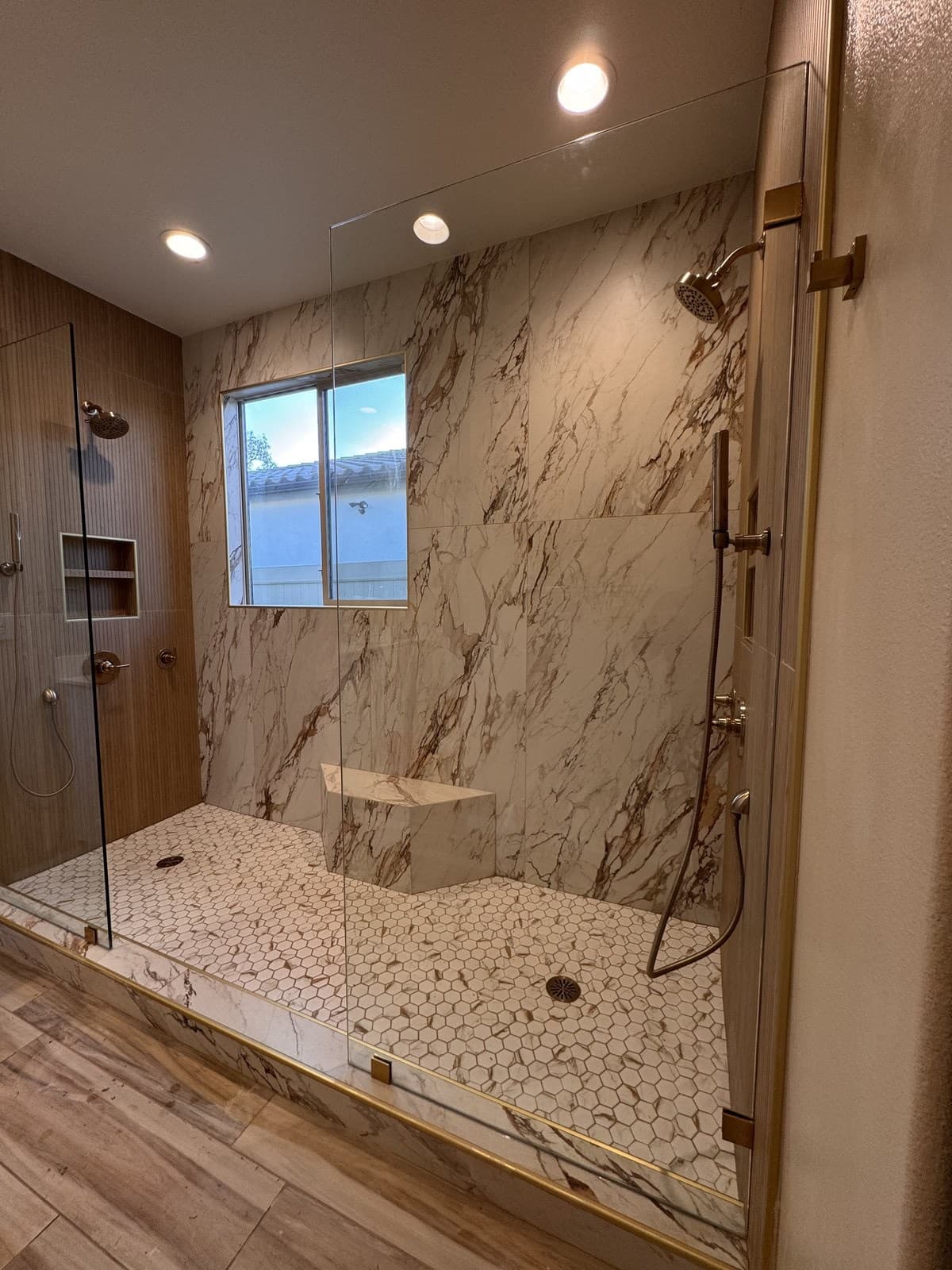 Walk-in shower through the glass panel, gold hardware